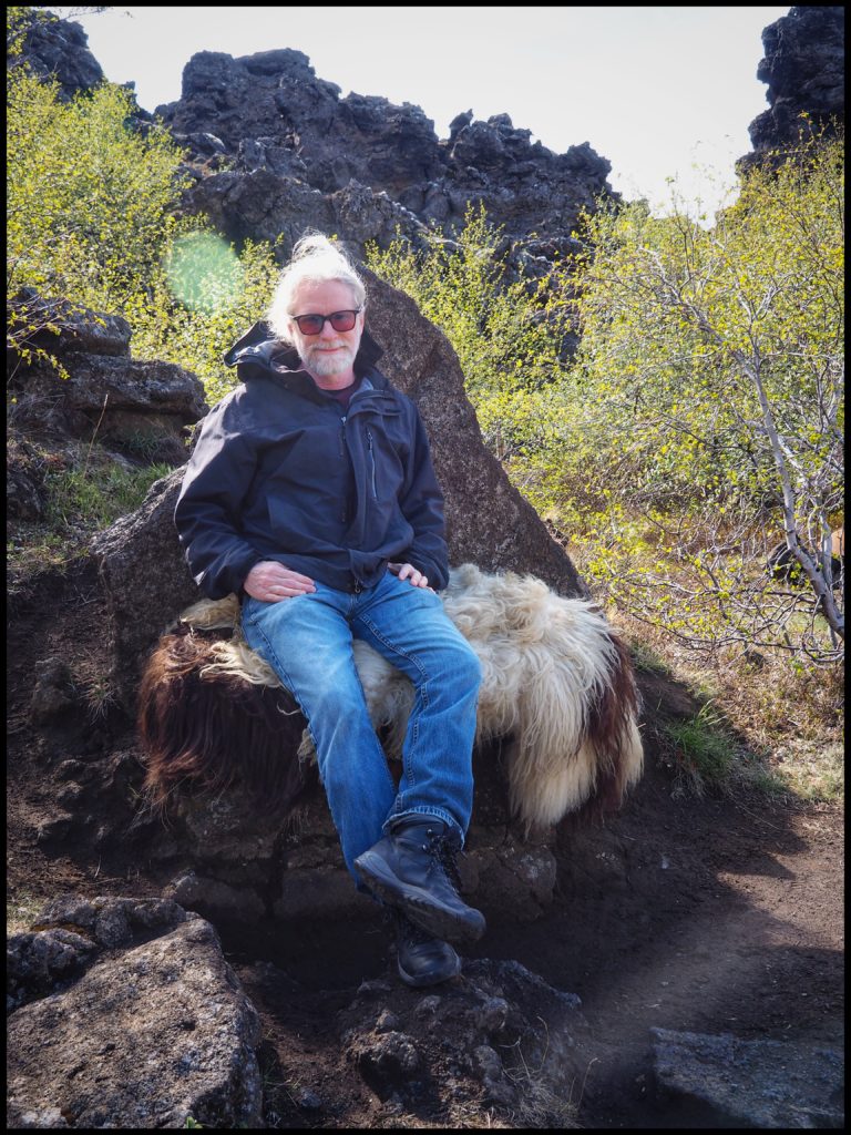 Man in fur covered chair