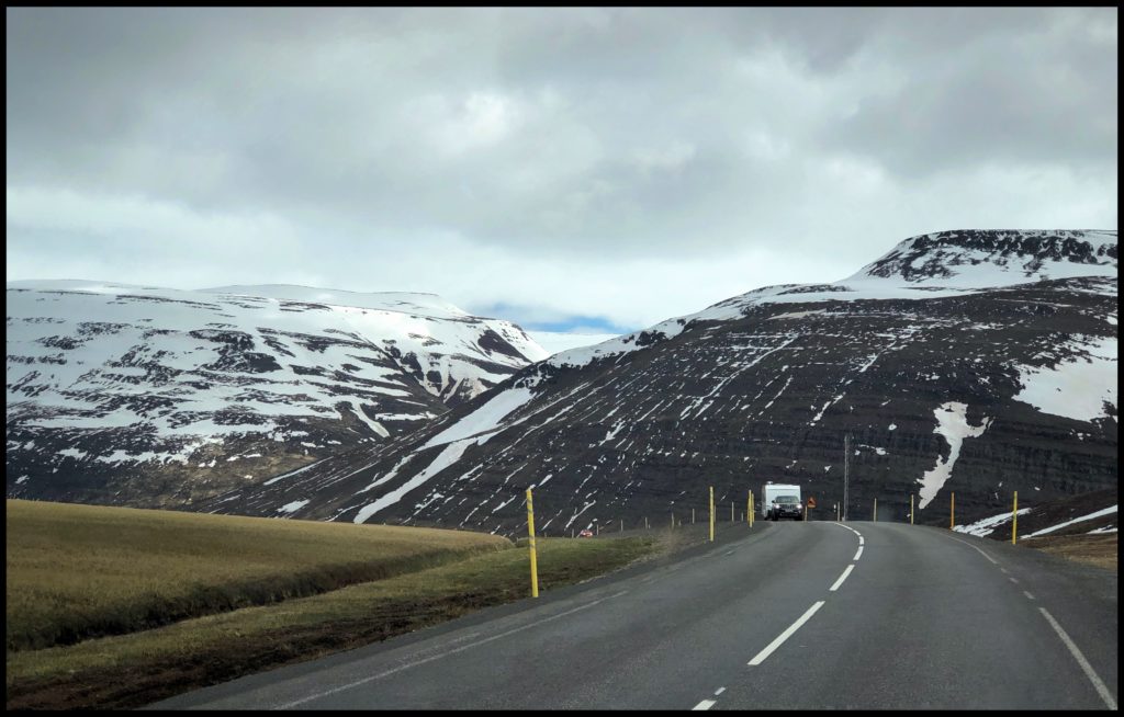 Black mountain tops with glaciers and clouds