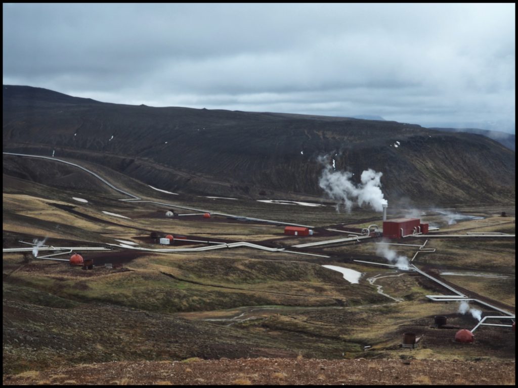 Steam power plant in valley of mountains