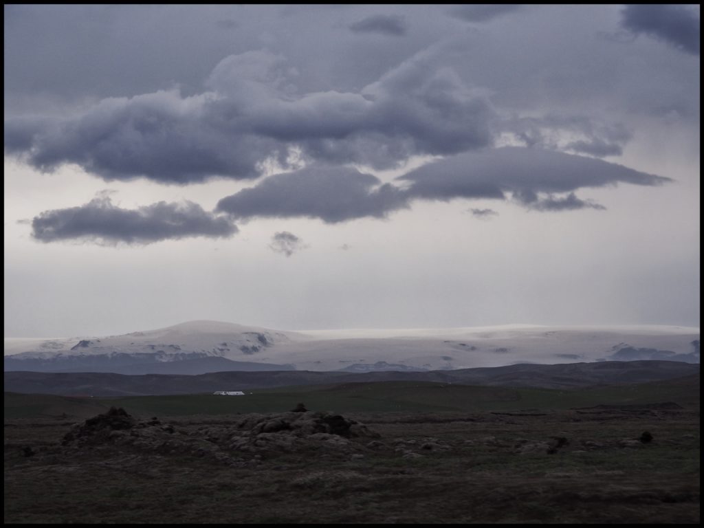 Dark stormy clouds over glacier in background